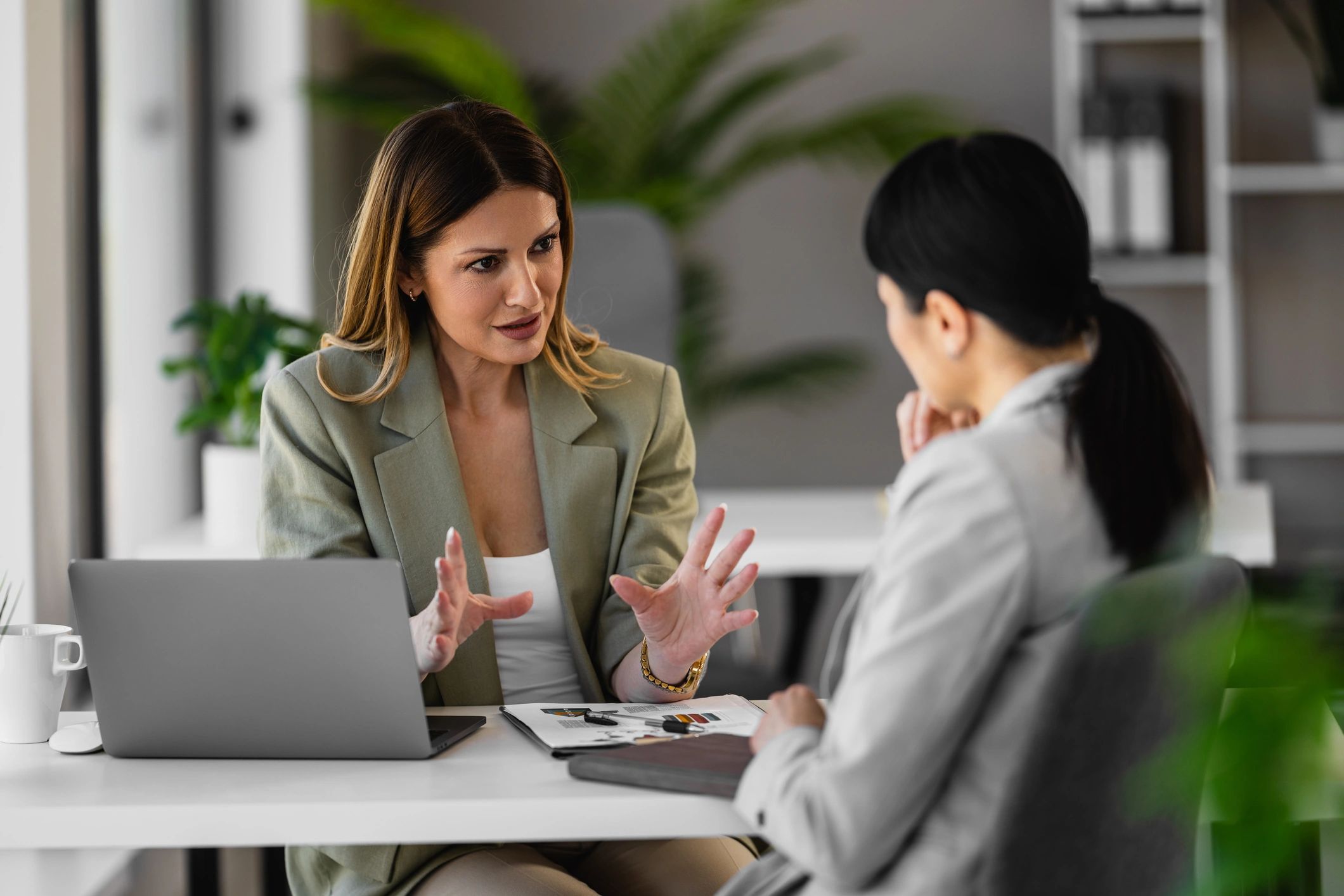 Advisor consulting with a colleague in a modern office